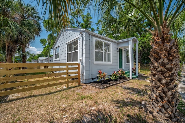 1527 E Lake Ave, Tampa, FL 33610 - view of property exterior with fence and crawl space