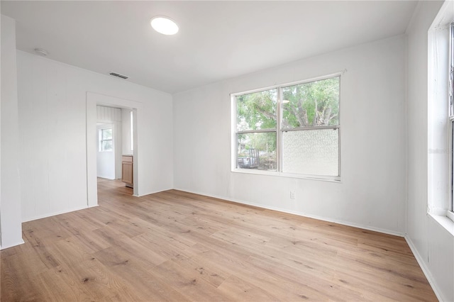1527 E Lake Ave, Tampa, FL 33610 - spare room with light wood-style floors and a smoke detector