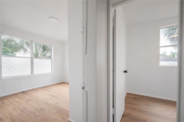 1527 E Lake Ave, Tampa, FL 33610 - hallway featuring healthy amount of natural light, wood finished floors, and baseboards