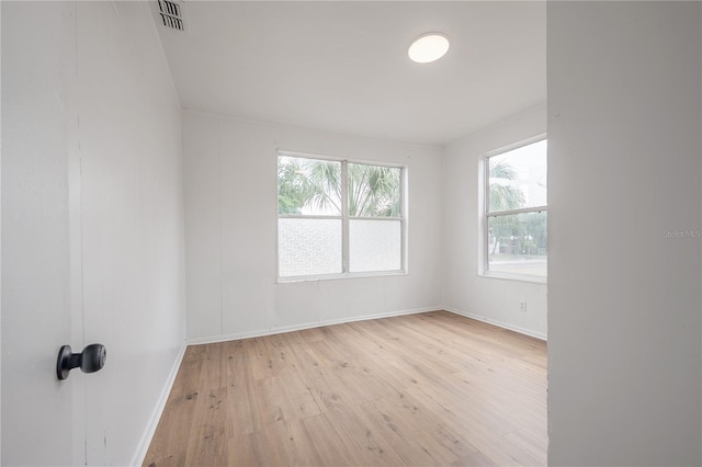 1527 E Lake Ave, Tampa, FL 33610 - empty room with light wood finished floors and baseboards