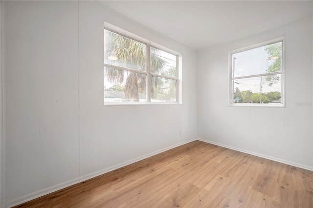 1527 E Lake Ave, Tampa, FL 33610 - unfurnished room with light wood-type flooring and baseboards