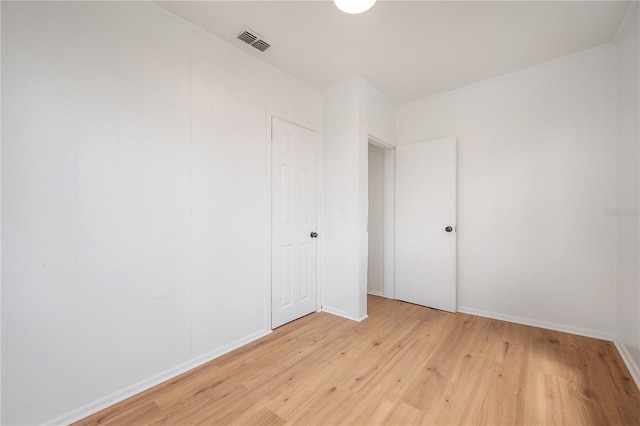 1527 E Lake Ave, Tampa, FL 33610 - empty room featuring light wood finished floors and baseboards