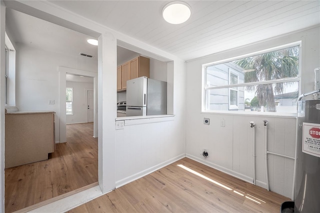 1527 E Lake Ave, Tampa, FL 33610 - laundry room featuring electric dryer hookup, light wood finished floors, healthy amount of natural light, and hookup for a washing machine