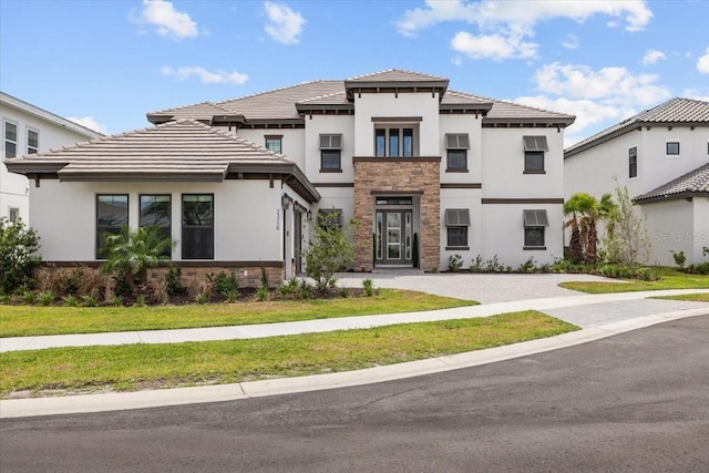 33750 Ocean Spray Ln, Wesley Chapel, FL 33543 - view of front of house featuring stone siding, stucco siding, and a tile roof