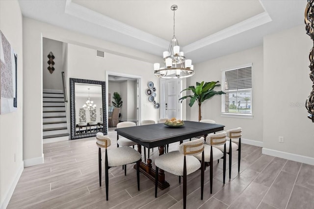 33750 Ocean Spray Ln, Wesley Chapel, FL 33543 - dining room with a chandelier, a raised ceiling, wood finish floors, and crown molding