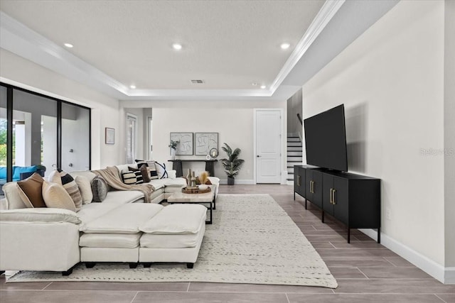 33750 Ocean Spray Ln, Wesley Chapel, FL 33543 - living area with a tray ceiling, recessed lighting, baseboards, crown molding, and wood tiled floors