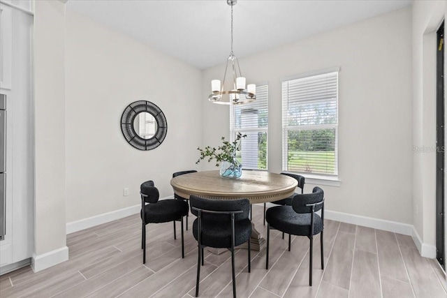 33750 Ocean Spray Ln, Wesley Chapel, FL 33543 - dining room with a chandelier, wood finish floors, and baseboards