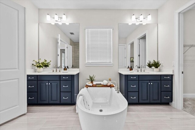 33750 Ocean Spray Ln, Wesley Chapel, FL 33543 - bathroom with a freestanding tub and two vanities