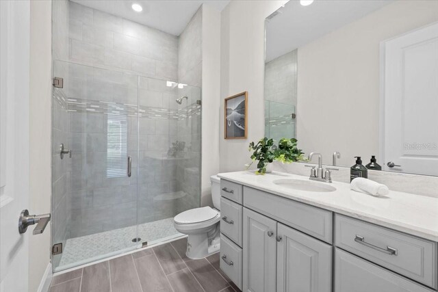 33750 Ocean Spray Ln, Wesley Chapel, FL 33543 - bathroom with a stall shower, toilet, vanity, recessed lighting, and wood finish floors