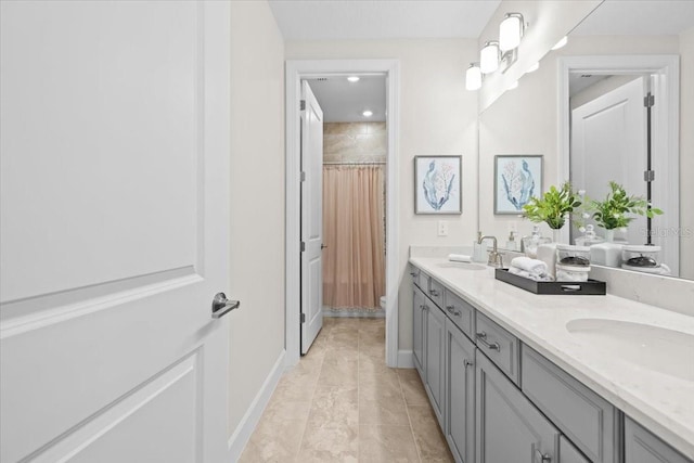 33750 Ocean Spray Ln, Wesley Chapel, FL 33543 - bathroom with curtained shower, baseboards, double vanity, and toilet