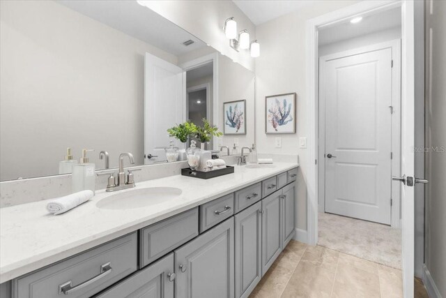 33750 Ocean Spray Ln, Wesley Chapel, FL 33543 - bathroom featuring double vanity and baseboards
