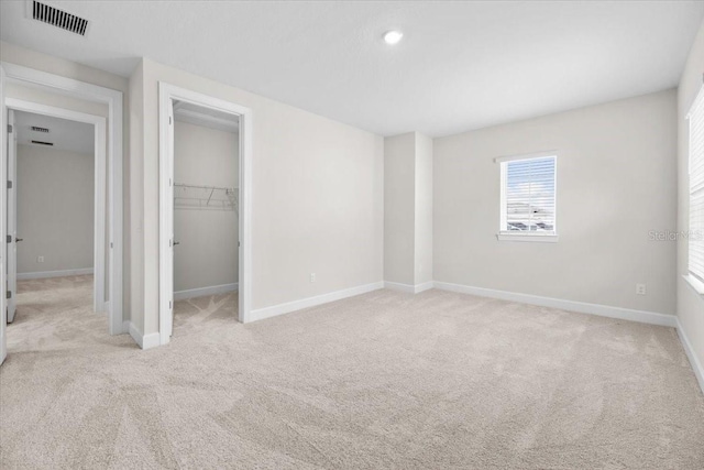 33750 Ocean Spray Ln, Wesley Chapel, FL 33543 - unfurnished bedroom featuring light carpet, baseboards, a spacious closet, a closet, and recessed lighting
