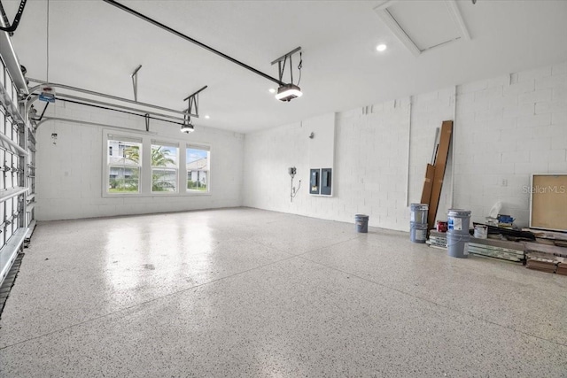 33750 Ocean Spray Ln, Wesley Chapel, FL 33543 - garage with a garage door opener, concrete block wall, electric panel, and recessed lighting