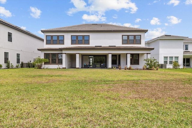 33750 Ocean Spray Ln, Wesley Chapel, FL 33543 - rear view of property with a lawn and stucco siding