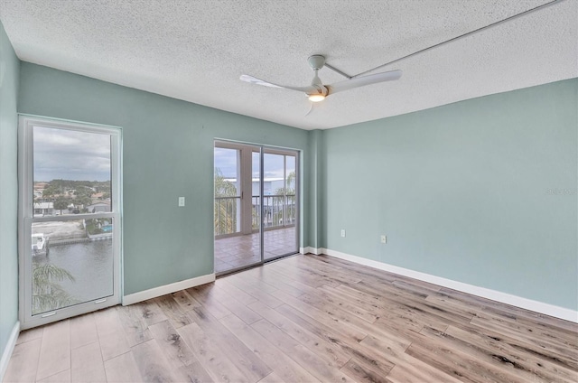 4904 38th Way S Unit 514, Saint Petersburg, FL 33711 - unfurnished room with wood finished floors, a textured ceiling, ceiling fan, and baseboards