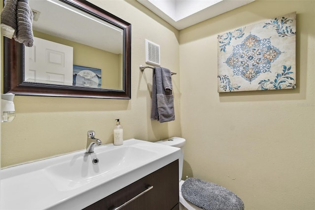 bathroom with toilet and vanity