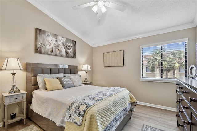 bedroom featuring crown molding, vaulted ceiling, wood finished floors, a textured ceiling, and baseboards