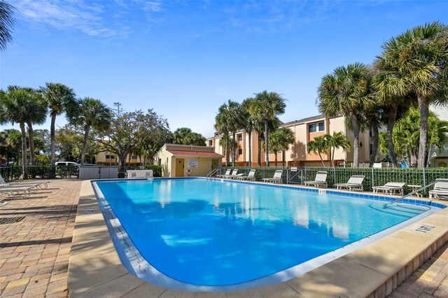 community pool featuring fence and a patio area
