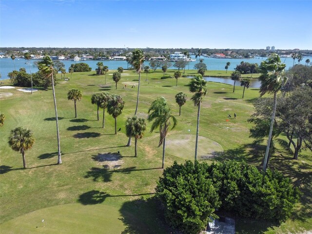 drone / aerial view of a golf course and a nearby body of water