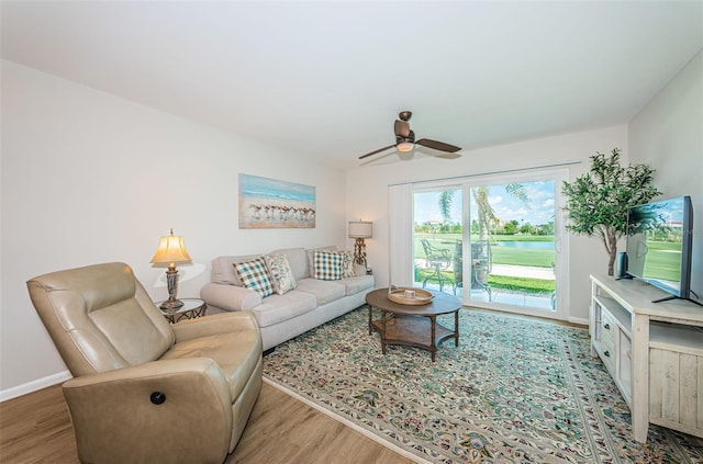 6151 Bahia Del Mar Blvd Unit 126, Saint Petersburg, FL 33715 - living area with wood finished floors, a ceiling fan, and baseboards