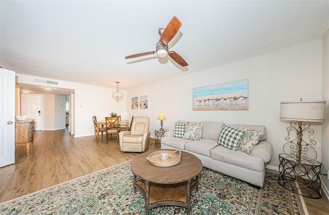 6151 Bahia Del Mar Blvd Unit 126, Saint Petersburg, FL 33715 - living area featuring light wood-style flooring, a ceiling fan, and baseboards