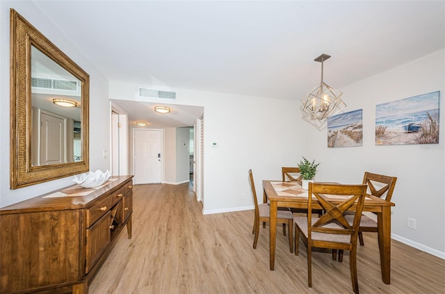 6151 Bahia Del Mar Blvd Unit 126, Saint Petersburg, FL 33715 - dining area featuring light wood-style floors, a chandelier, and baseboards