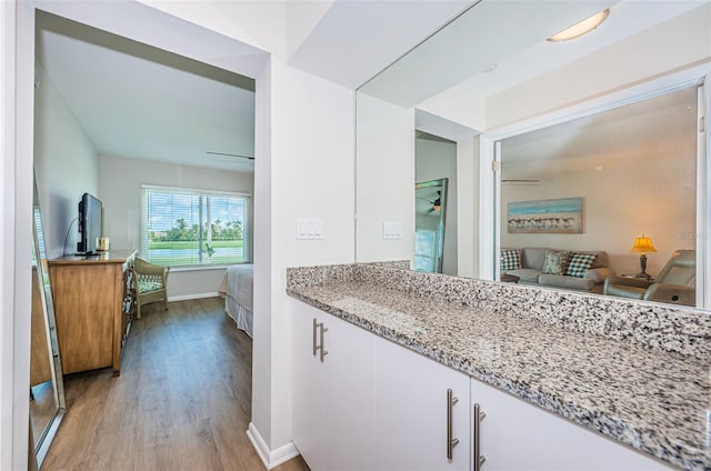 6151 Bahia Del Mar Blvd Unit 126, Saint Petersburg, FL 33715 - bathroom featuring wood finished floors, ensuite bath, baseboards, and vanity