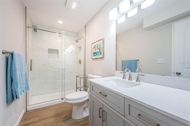 6151 Bahia Del Mar Blvd Unit 126, Saint Petersburg, FL 33715 - bathroom featuring toilet, a marble finish shower, wood finished floors, and vanity