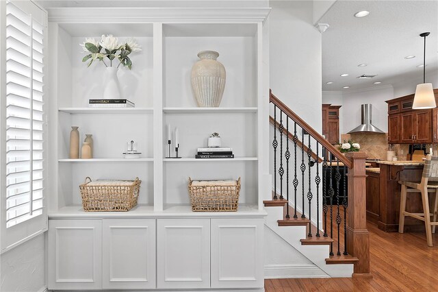 2936 W Knights Ave Unit A, Tampa, FL 33611 - stairway with wood finished floors, built in shelves, recessed lighting, and crown molding