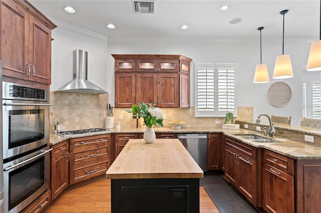 2936 W Knights Ave Unit A, Tampa, FL 33611 - kitchen with a sink, stainless steel appliances, wooden counters, wall chimney exhaust hood, and a peninsula