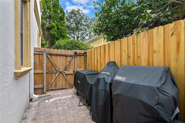 2936 W Knights Ave Unit A, Tampa, FL 33611 - view of patio featuring a gate, a grill, and fence