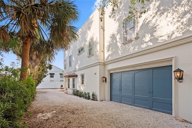 2936 W Knights Ave Unit A, Tampa, FL 33611 - view of property exterior with driveway, stucco siding, and an attached garage