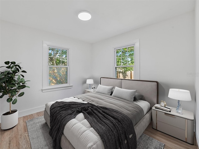 3305 10th Ave N, Saint Petersburg, FL 33713 - bedroom with multiple windows, light wood-type flooring, and baseboards