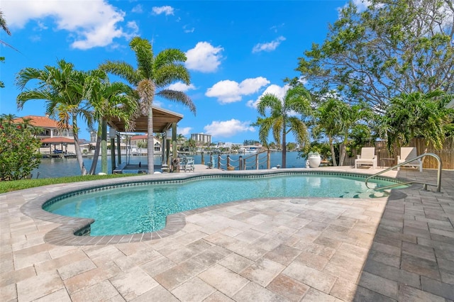 106 Midway Is, Clearwater Beach, FL 33767 - swimming pool featuring boat lift, a water view, a boat dock, and a patio area