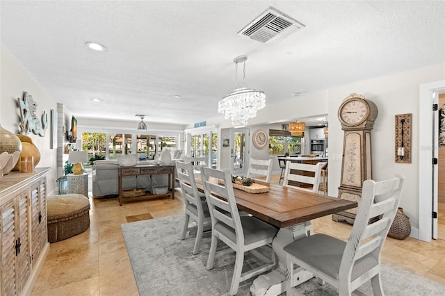 106 Midway Is, Clearwater Beach, FL 33767 - dining area featuring a chandelier, recessed lighting, and a textured ceiling