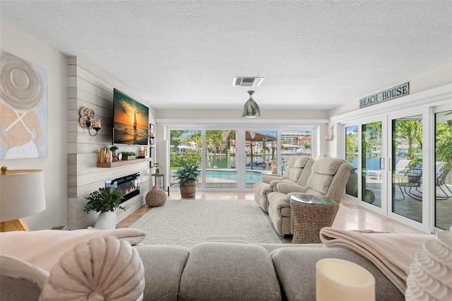 106 Midway Is, Clearwater Beach, FL 33767 - living area with a glass covered fireplace and a textured ceiling