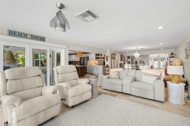 106 Midway Is, Clearwater Beach, FL 33767 - living area featuring a chandelier and recessed lighting