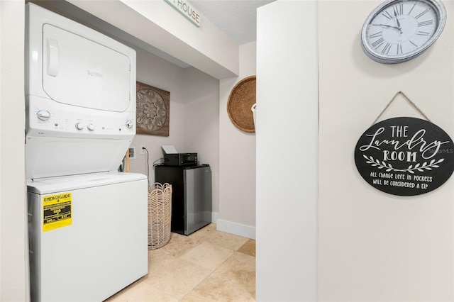 106 Midway Is, Clearwater Beach, FL 33767 - laundry room featuring stacked washer and clothes dryer and baseboards