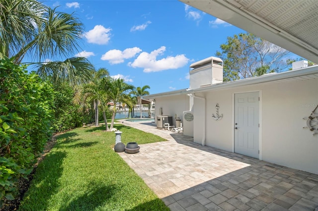 106 Midway Is, Clearwater Beach, FL 33767 - view of grassy yard with a patio and an outdoor pool