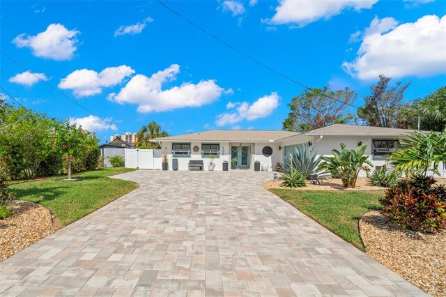 106 Midway Is, Clearwater Beach, FL 33767 - ranch-style home with decorative driveway and stucco siding