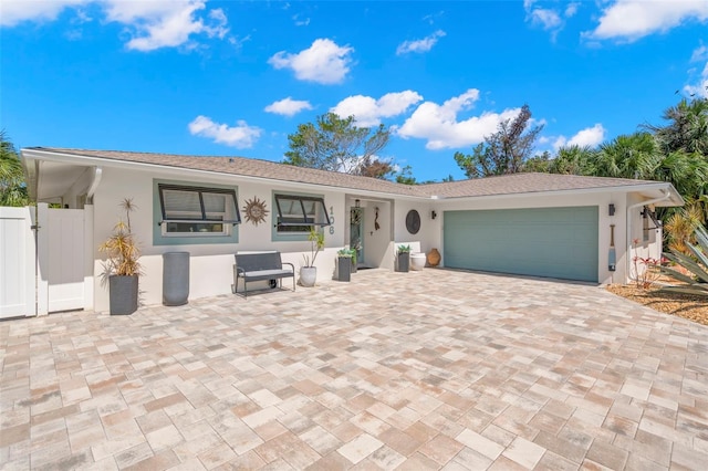 106 Midway Is, Clearwater Beach, FL 33767 - single story home featuring stucco siding, a garage, and decorative driveway