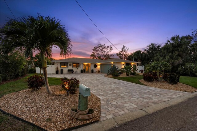 106 Midway Is, Clearwater Beach, FL 33767 - view of front of property featuring decorative driveway, a garage, and stucco siding