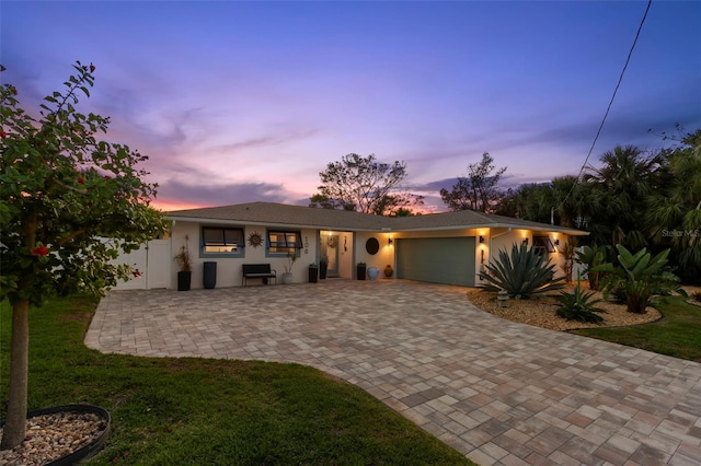 106 Midway Is, Clearwater Beach, FL 33767 - single story home featuring an attached garage, driveway, and stucco siding