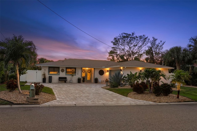 106 Midway Is, Clearwater Beach, FL 33767 - view of front of property featuring decorative driveway and stucco siding
