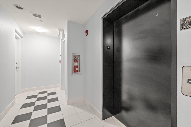 hall with elevator and baseboards