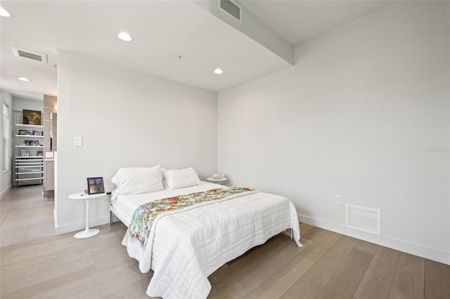 bedroom with hardwood / wood-style flooring, baseboards, and recessed lighting