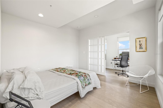 bedroom featuring a desk, light wood-style floors, recessed lighting, and baseboards