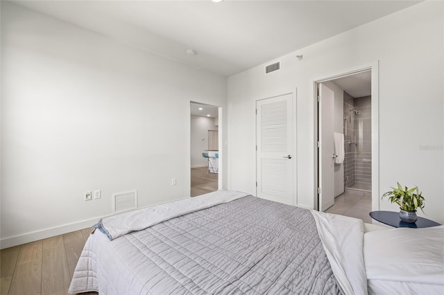 bedroom featuring baseboards, light wood-type flooring, connected bathroom, and recessed lighting