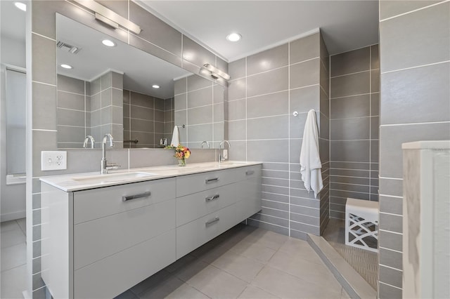 205 5th Ave N Unit 501, Saint Petersburg, FL 33701 - bathroom with tile walls, tile patterned floors, double vanity, and recessed lighting