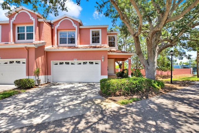 14561 El Paseo Dr, Seminole, FL 33776 - view of front of home featuring stucco siding, an attached garage, and driveway